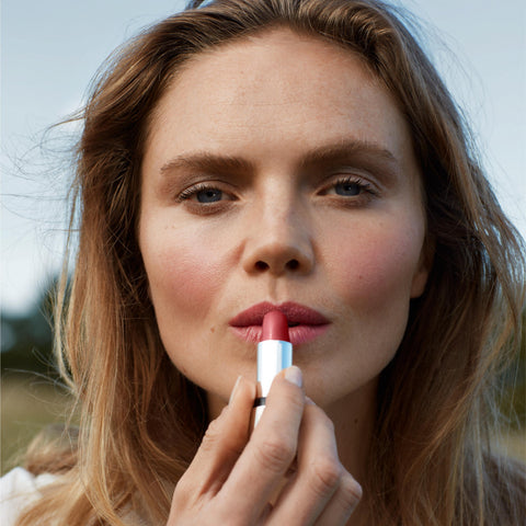 Model applying Kjaer Weis lipstick